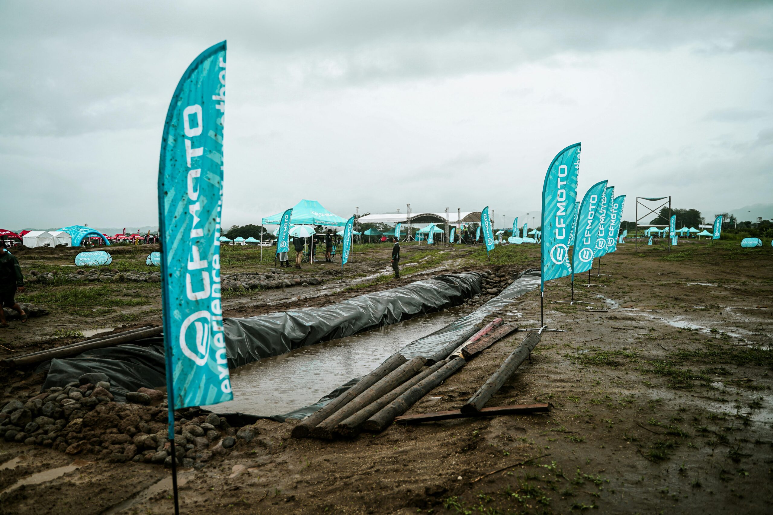 Rainy day outdoor event with CFMOTO branding in Bulakan, Central Luzon.