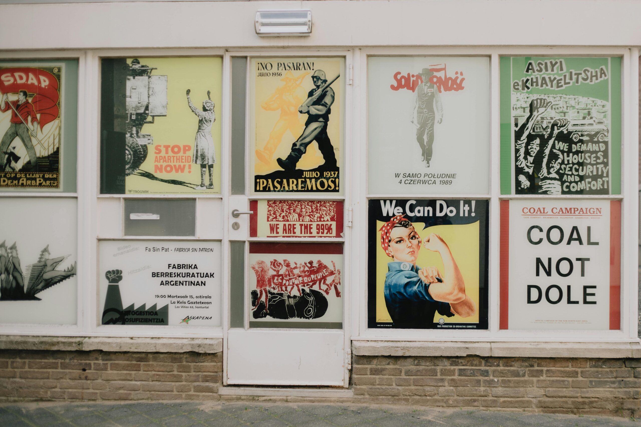 Collection of vintage political posters displayed on a storefront in Maastricht, Netherlands.